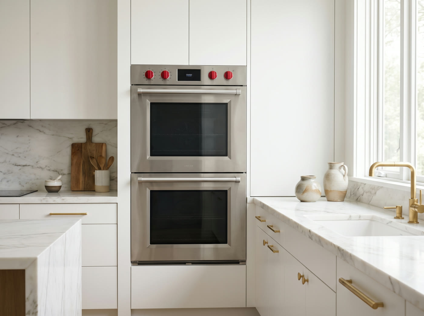 A built in double wall oven in a white kitchen